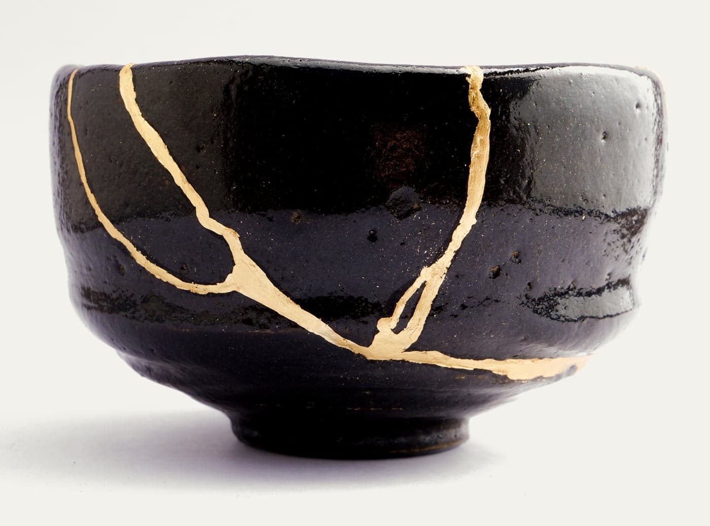 A black tea bowl mended with gold along its cracks